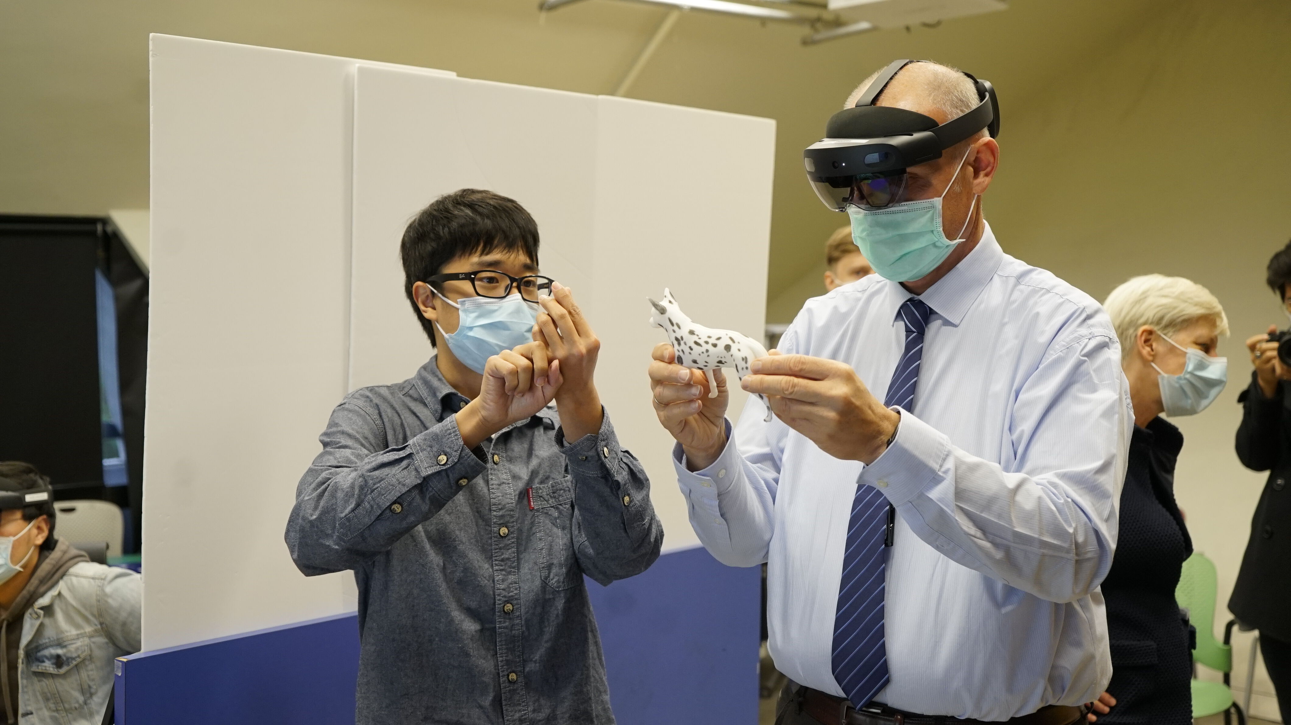  Qiaochu Wang shows his demo Veterinary Healthcare Training with AR to Prof. Nikolaus Osterrieder, the Dean of Jockey Club College of Veterinary Medicine and Life Sciences (JCC).