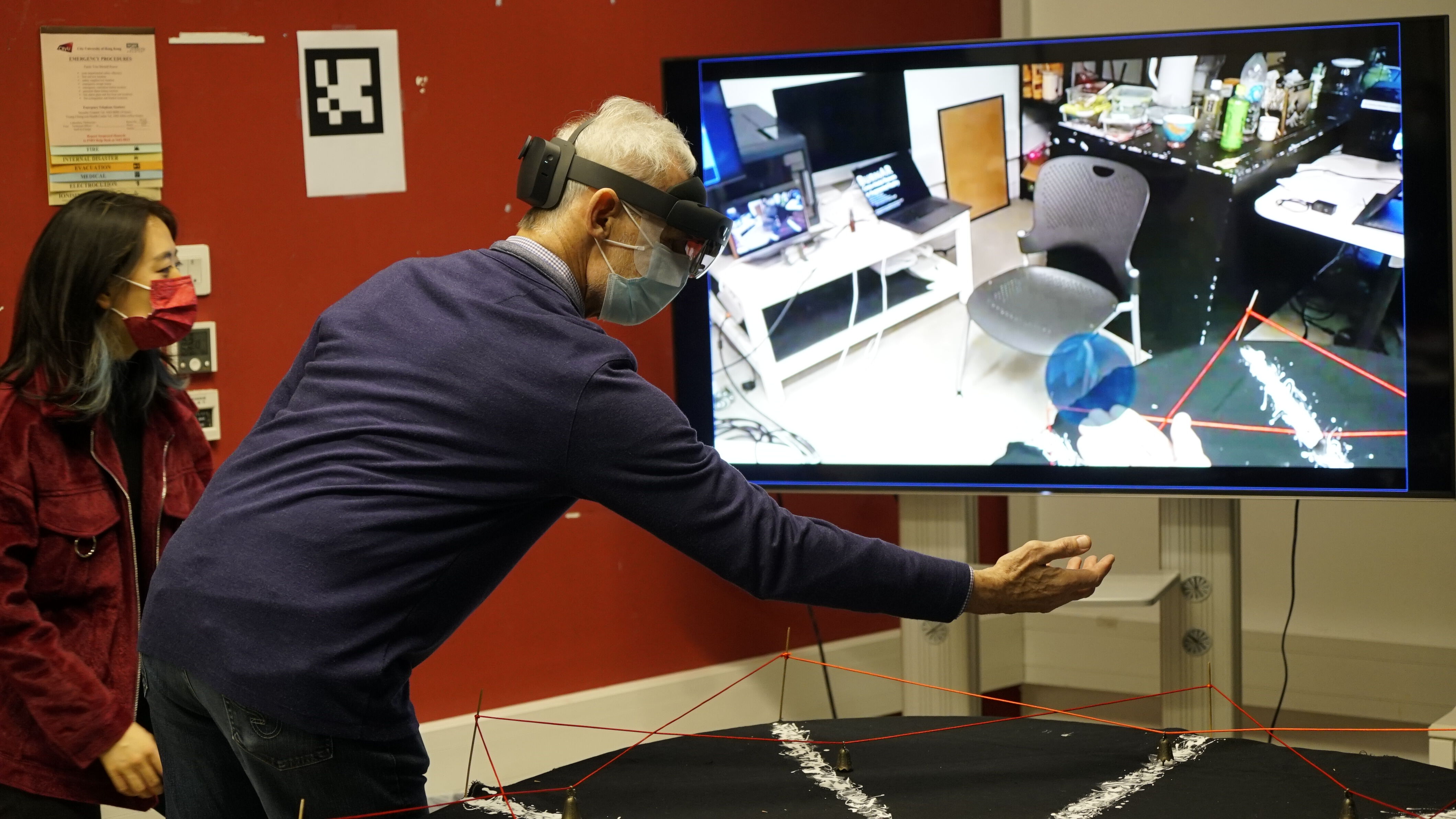  Prof. Robert Ransom (Head, Department of Neuroscience) investigates Chang Liu’s demo Interactive AR Storytelling.